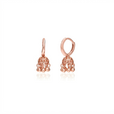 small rose gold jhumka indian earrings against a white background
