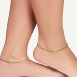 model wearing chain anklets on both feet